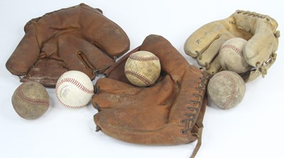 Lot 557 - A collection of vintage baseball balls and gloves