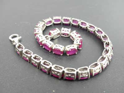 Lot 309 - A modern silver and red paste set bracelet;...