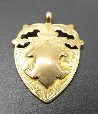 Lot 314 - A 9ct gold shield shaped medallion pendant,...