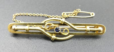 Lot 315 - An Edwardian 15ct gold and sapphire set bar...