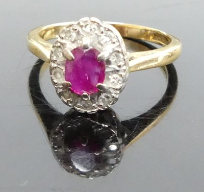 Lot 365 - An 18ct gold, ruby and diamond oval cluster...