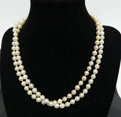 Lot 409 - A cultured and knotted pearl single string...