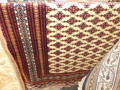Lot 1165 - A Persian woollen red and cream ground Bokhara...