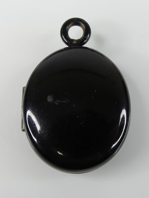 Lot 423 - A Victorian jet oval mourning locket, h.34mm...