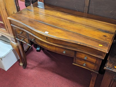 Lot 1194 - A contemporary cherry wood kneehole serpentine...