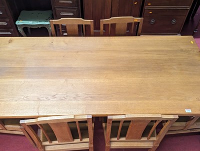 Lot 1204 - A blond oak dining suite comprising refectory...