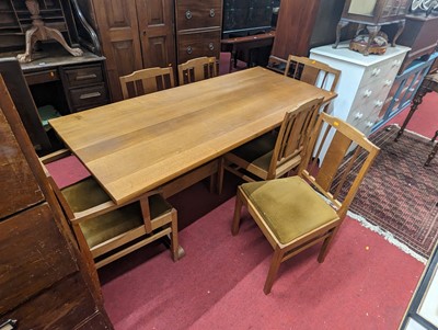 Lot 1204 - A blond oak dining suite comprising refectory...