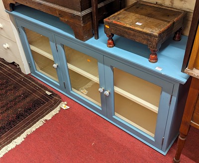 Lot 1212 - A contemporary blue painted pine three-door...