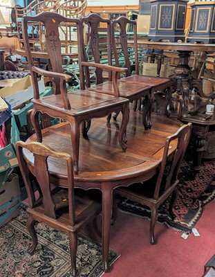 Lot 1307 - A contemporary Chinese hardwood dining suite,...