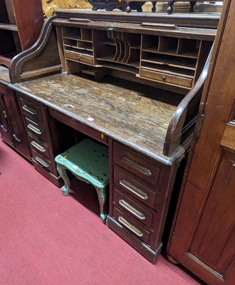 Lot 1247 - A 1930s oak kneehole roll-top desk, having a...