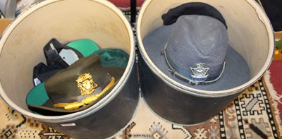 Lot 1669 - Two boxes of assorted hats, to include Police...