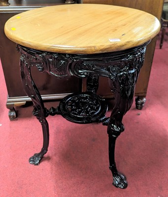 Lot 1257 - A black painted cast iron based and beech...