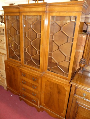 Lot 1355 - A reproduction yew wood breakfront bookcase,...