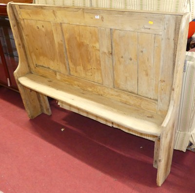 Lot 1367 - A rustic joined and panelled pine bench settle,...