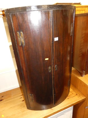 Lot 1382 - A George III mahogany bowfront double door...