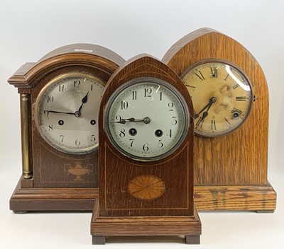 Lot 1550 - An Edwardian inlaid oak Gothic mantel clock,...