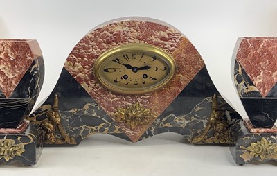 Lot 1531 - An Art Deco rouge marble three-piece clock...