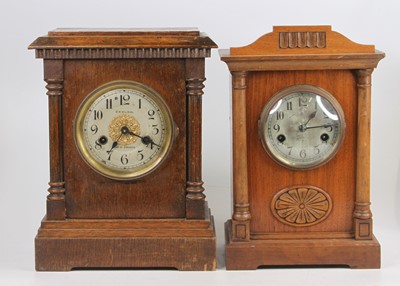 Lot 1597 - An early 20th century oak mantel clock, the...