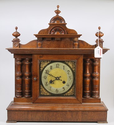 Lot 1607 - A circa 1900 oak mantel clock of architectural...