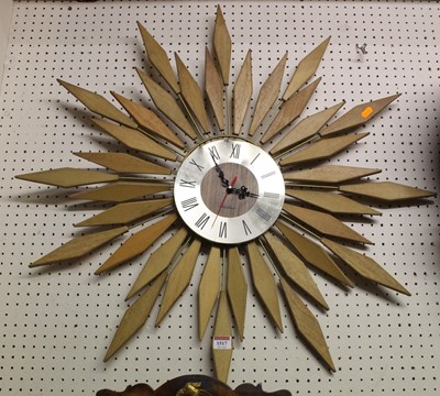 Lot 1517 - Seth Thomas - a sunburst wall clock, having...