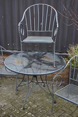 Lot 1398 - A wired metal patio suite comprising circular...