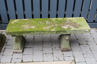 Lot 1403 - A concrete garden bench raised on twin...