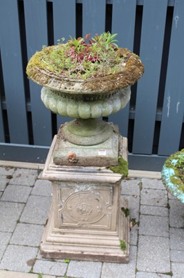 Lot 1405 - A reconstituted stone pedestal planter, raised...