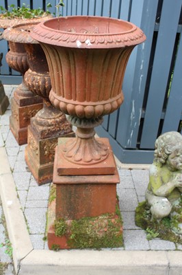 Lot 1409 - A terracotta fluted pedestal garden urn,...