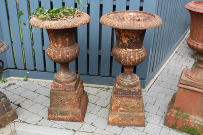 Lot 1410 - A pair of cast iron pedestal garden urns, each...