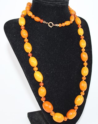 Lot 2766 - A butterscotch amber necklace, arranged as...