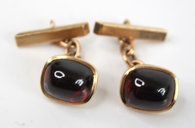 Lot 2773 - A pair of yellow metal and cabochon garnet...