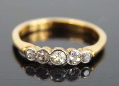 Lot 2872 - A yellow metal diamond set half hoop ring,...