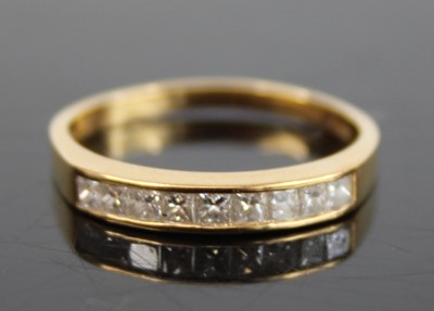 Lot 2873 - A modern 18ct gold diamond half hoop ring,...