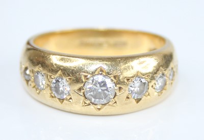 Lot 2721 - An 18ct yellow gold diamond set band,...