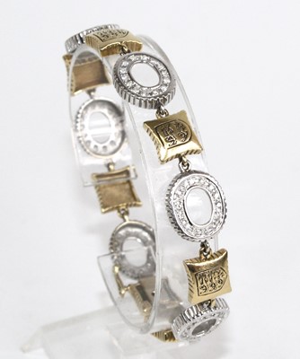 Lot 2229 - A yellow and white metal diamond set bracelet,...