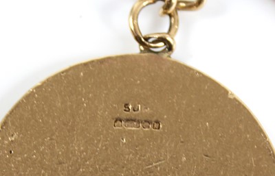 Lot 2404 - A 9ct gold keyring of triangular shape and...
