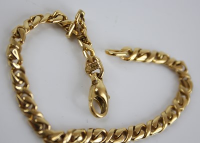 Lot 2410 - A modern 18ct gold flat curblink bracelet,...