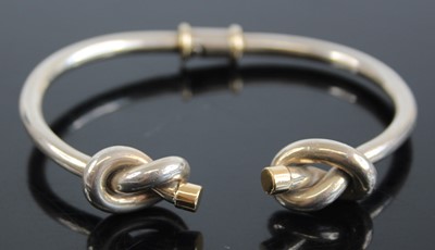 Lot 2440 - A Gucci silver and 18ct gold tipped bangle,...