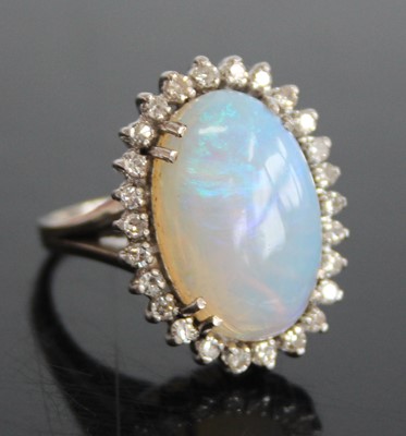 Lot 2444 - A 9ct white gold, opal and diamond oval...