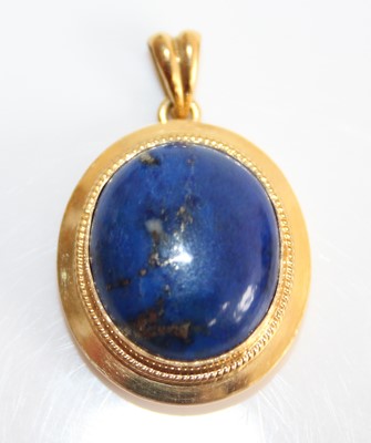 Lot 2445 - An 18ct yellow gold and lapis lazuli pendant,...