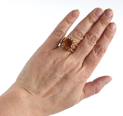 Lot 2430 - A yellow metal and citrine set dress ring, the...