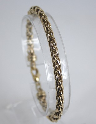 Lot 2855 - A modern 9ct gold spiga link bracelet, with...