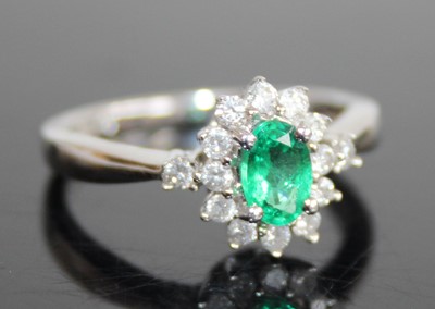 Lot 2432 - A contemporary 14ct white gold, emerald and...