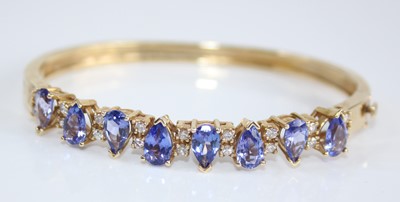 Lot 2426 - A contemporary yellow metal, tanzanite and...
