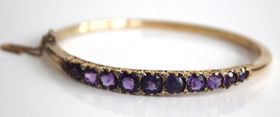 Lot 2450 - A yellow metal, amethyst and diamond point set...