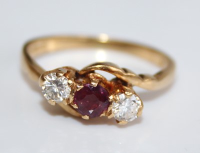 Lot 2455 - An 18ct gold, ruby and diamond three-stone...