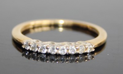 Lot 2468 - A modern 18ct gold diamond half hoop ring,...