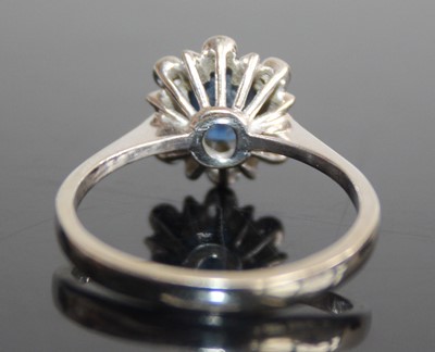 Lot 2470 - A white metal, sapphire and diamond flower...