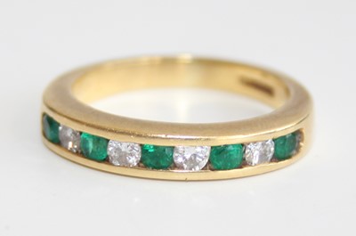 Lot 2822 - An 18ct gold, emerald and diamond half...