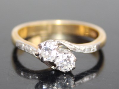 Lot 2790 - An 18ct gold diamond crossover ring, arranged...